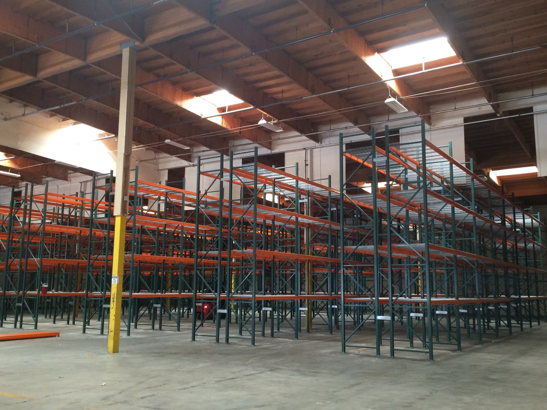 Rows of industrial pallet rack installed across a warehouse floor