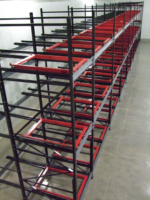 Push back pallet rack carts and rails installed in a cold storage room