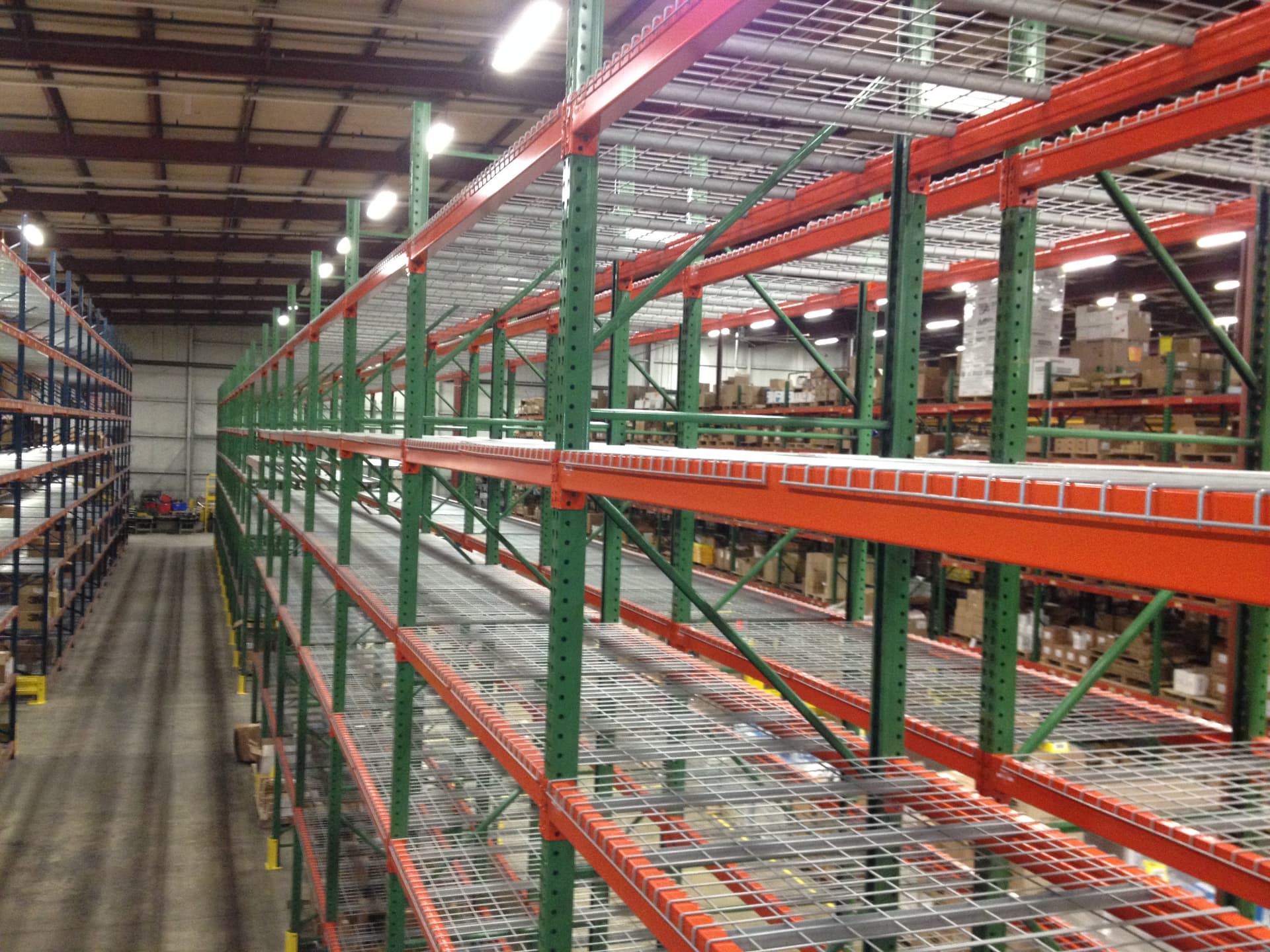 Warehouse pallet racking rows fitted with wire mesh decking