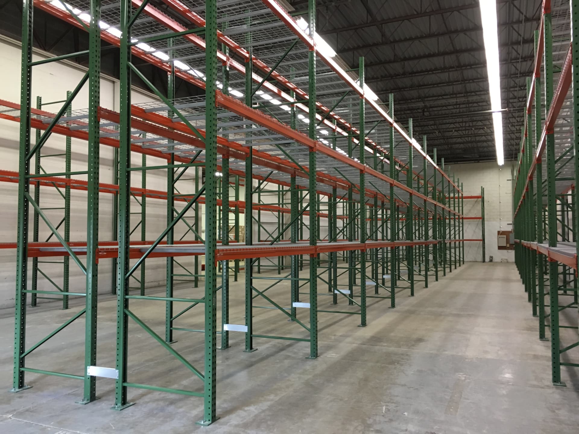 Long rows of pallet racks installed in a distribution center